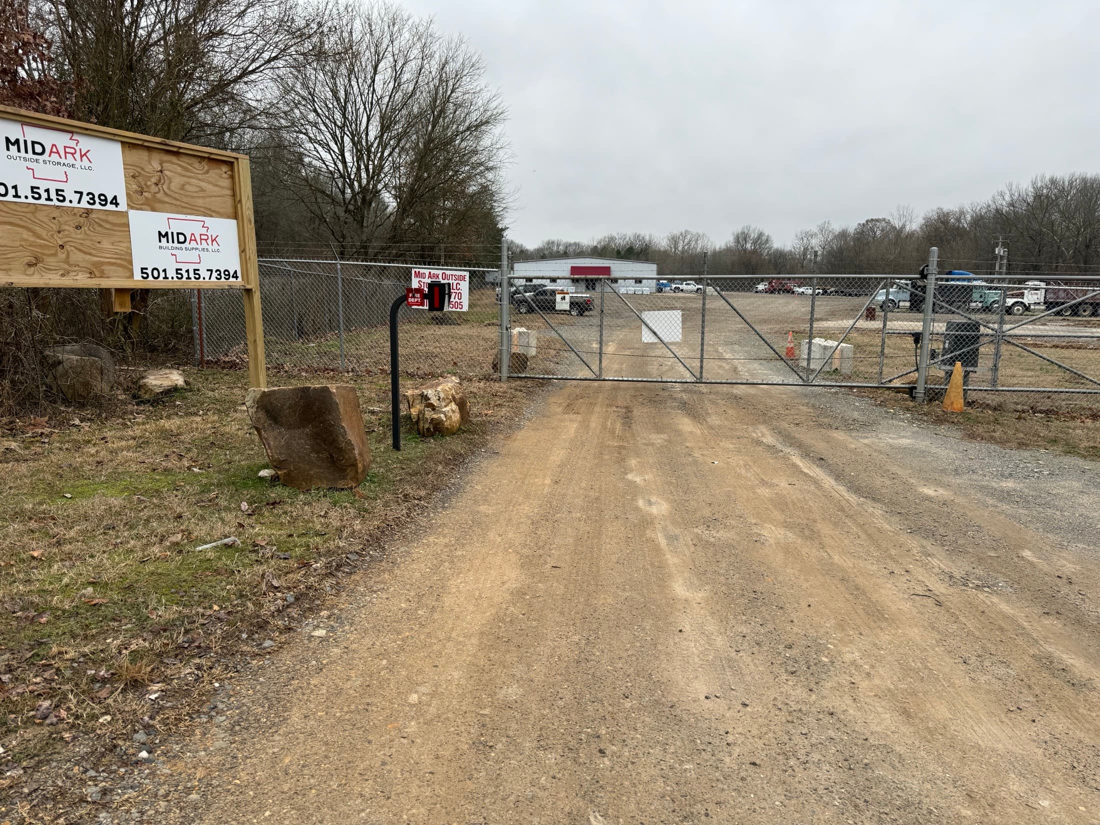 Camera-monitored entry gate and MidArk sign at the yard entrance
